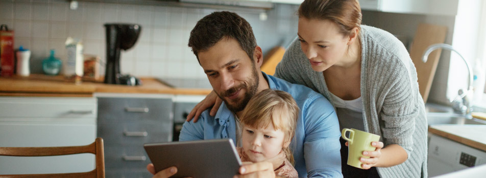 family of three looking at tablet wondering what to do without dental insurance