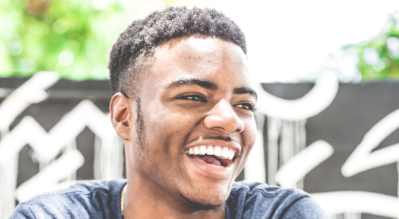 Brunette man smiling after professional teeth whitening at Southwest Smiles