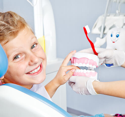 young boy sitting in a dental chair