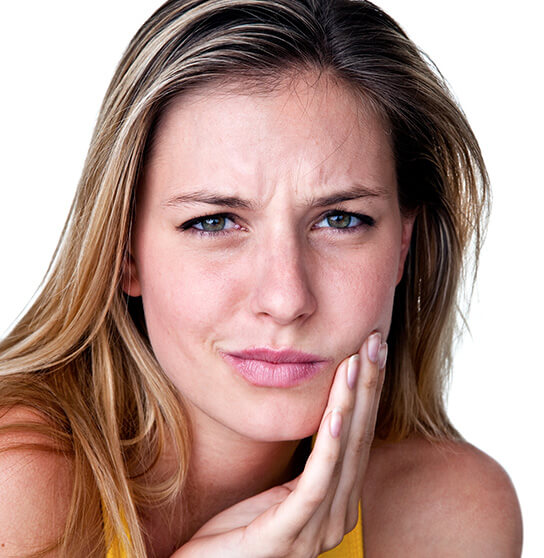 woman holding her jaw in pain