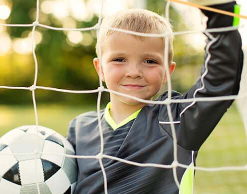 young boy holding a soccer ball