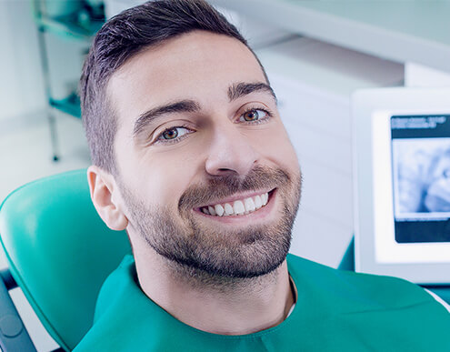 smiling man in dental chair