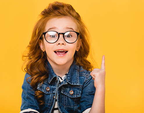 young girl holding finger up