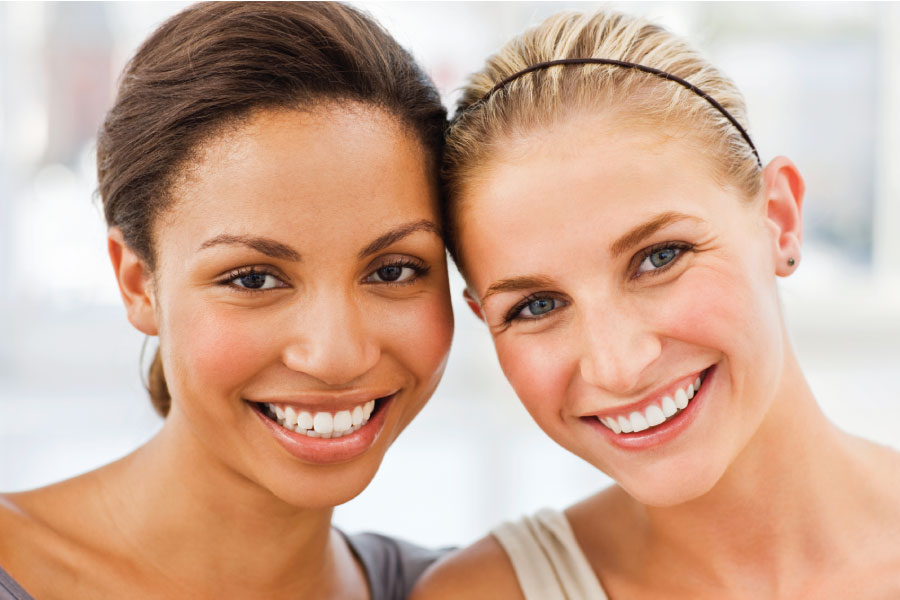 Two women smile in South Austin after improving their smiles with cosmetic dentistry at Southwest Smiles