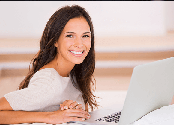 woman with computer smiling