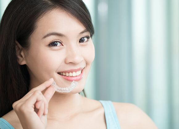 smiling woman with clear aligner