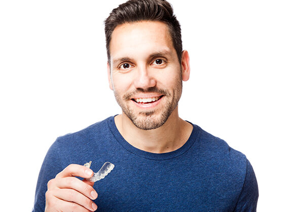 man smiling with clear aligner