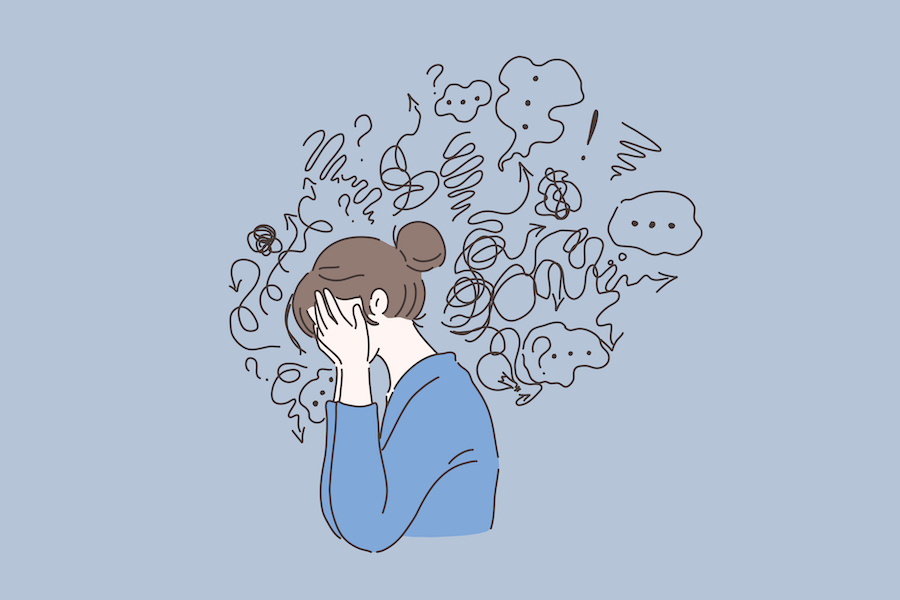 Illustration of a brunette woman in a blue shirt with her head in her hands surrounded by scribbles that represent stress and mental turmoil