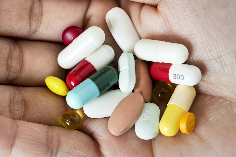 Aerial view of a pile of pills being held in a palm