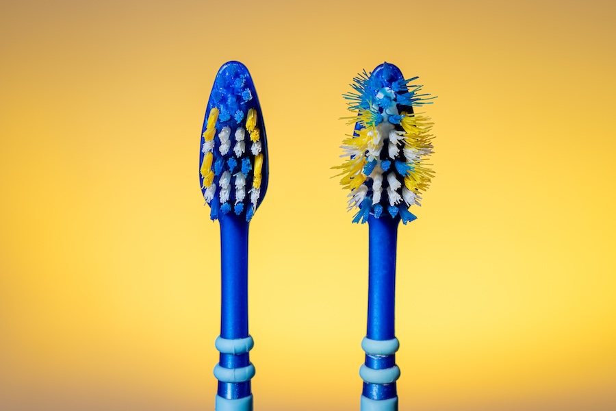 two toothbrushes, one worn out, when to replace your toothbrush