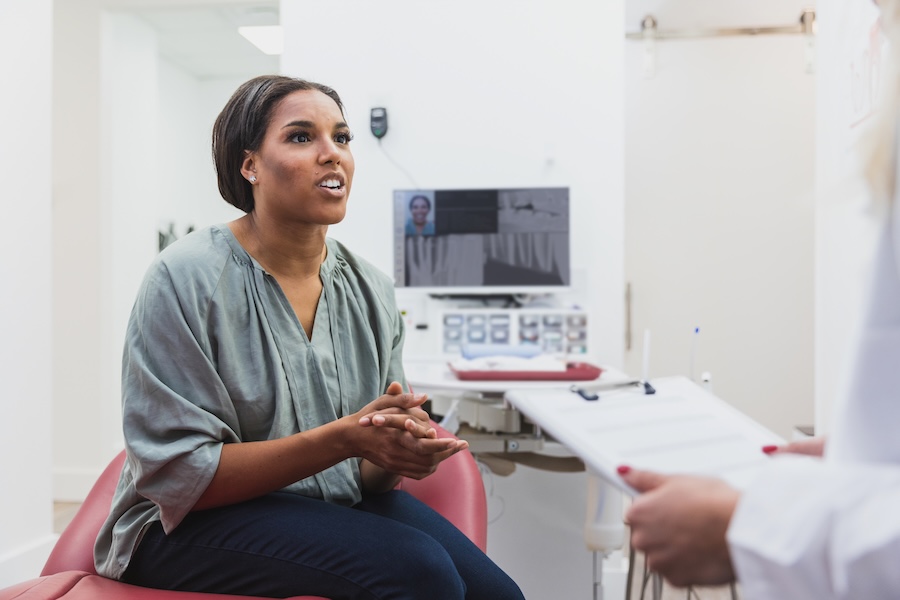 woman learning about gum disease treatment, deep cleaning, gingivitis